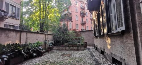 an alley in a city with a building at Cenacolo Apartment in Milan