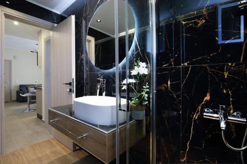 a bathroom with a sink and a mirror at Kallithea Guesthouse in Nydri