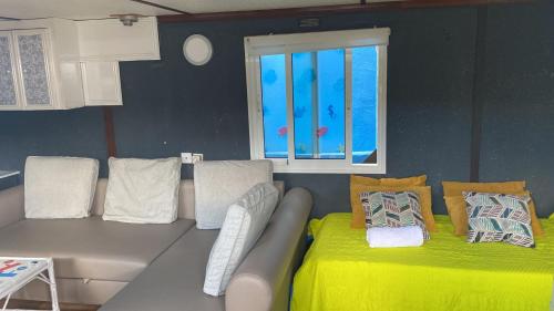a living room with a couch and a window at Relax in pasito blanco camping house in Maspalomas