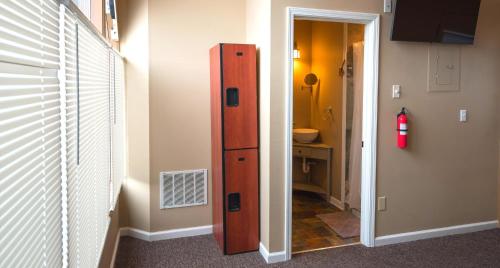 a room with a wooden cabinet next to a hallway at Wine View Room in Nashville