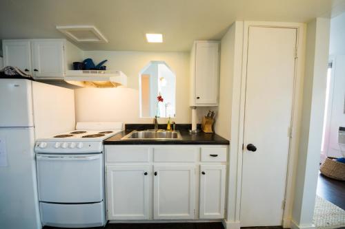 a white kitchen with a sink and a stove at Lake House in Nashville