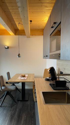 a kitchen with a table with a laptop on it at Mountain Moments Tannheim - Familie Weber in Tannheim