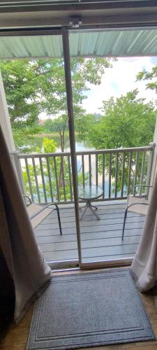 a screened in porch with a table and chairs at Captain's Quarters Riverfront #2 in Nashville