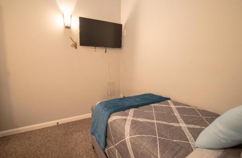 a bedroom with a bed and a flat screen tv on the wall at Girlfriend Getaway Suite in Nashville