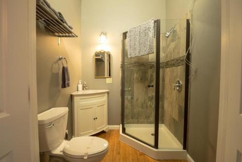 a bathroom with a shower and a toilet and a sink at Girlfriend Getaway Suite in Nashville