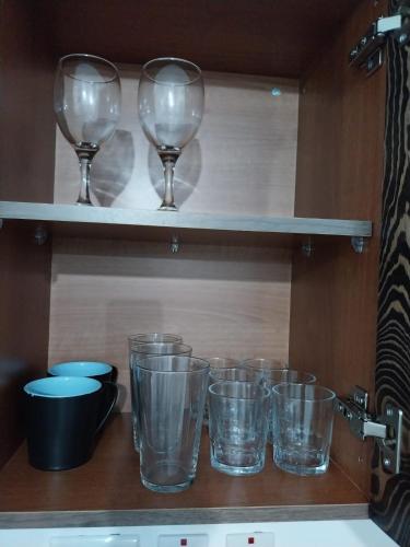 a row of wine glasses sitting on a shelf at St Gaetan Accomodation 6B in Hamrun
