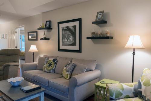 a living room with a couch and a table at 1135 Summerwind Cottage in Seabrook Island
