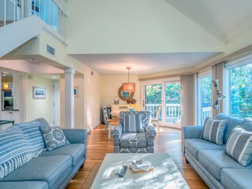 a living room with blue couches and a table at 779 Spinnaker Beach House in Seabrook Island