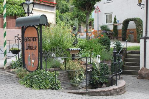 a garden with a sign that reads scientific garden ranger at Gasthof Jäger in Heppenheim an der Bergstrasse