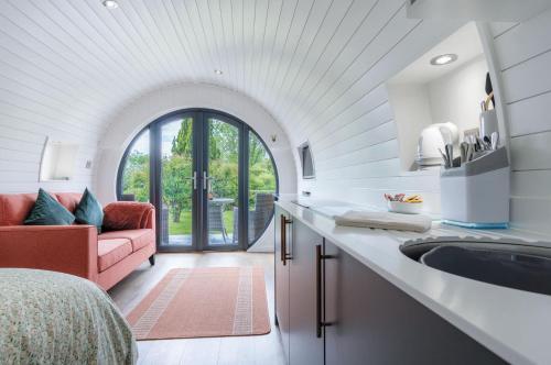 a kitchen with a sink and a living room with a couch at Woody's - 1 Bedroom Pod - Cold Inn in East Williamston