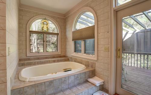 a bathroom with a tub and two windows at Mountain Memories - Viking gas range GE double ovenwarmer Lake views in Marblehill