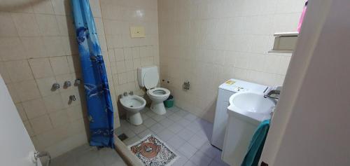 a bathroom with a shower and a toilet and a sink at Manantial Departamentos in Gualeguay