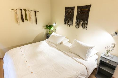 a bedroom with a white bed with two pillows at Montaña Blanca in Farellones