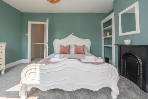 a bedroom with a large white bed with blue walls at Delightful Blue Shells Cottage - 2bedrooms -Garden - 5mins beach - 1min Shell Grotto in Kent
