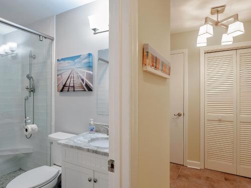 a white bathroom with a toilet and a sink at 2631 Seabrook Island Road in Seabrook Island