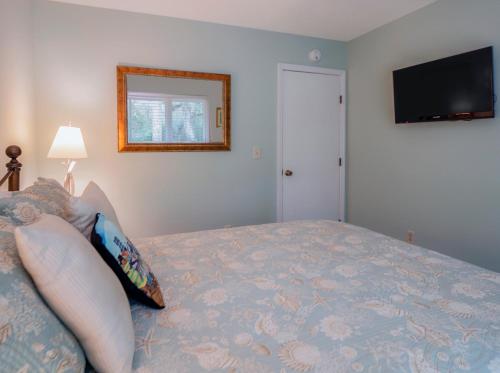 a bedroom with a bed and a flat screen tv at 2631 Seabrook Island Road in Seabrook Island