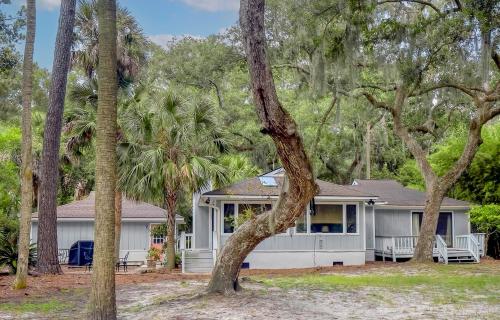 a white house with palm trees in front of it at 2631 Seabrook Island Road in Seabrook Island