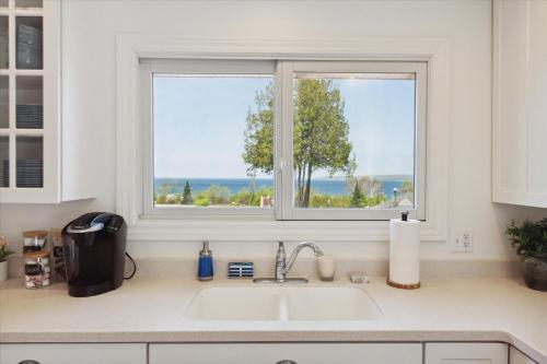 a kitchen with a sink and a window at Lake Front home 5Min to DTPetoskey W D Fireplace King in Petoskey