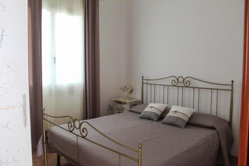 a bedroom with a bed with two pillows on it at Sunrise Apartment in Castelsardo