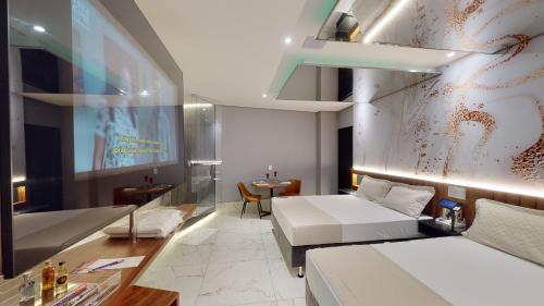 a hotel room with a bed and a table at Motel DUBAI BH in Belo Horizonte