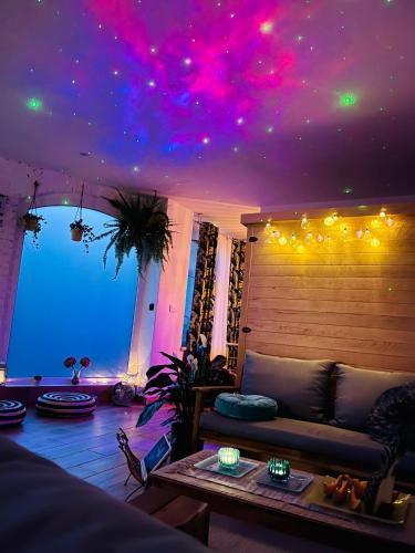 a living room with a couch and a ceiling with lights at wySPAne Katowice in Katowice