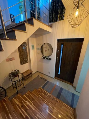 an empty room with a staircase and a wooden door at wySPAne Katowice in Katowice