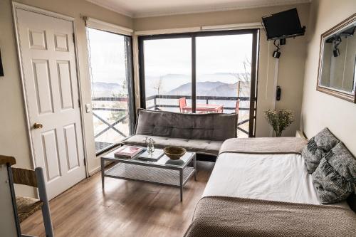 a living room with a couch and a table at Montaña Blanca in Farellones