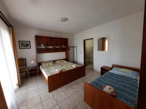 Postel nebo postele na pokoji v ubytování Apartments Dario