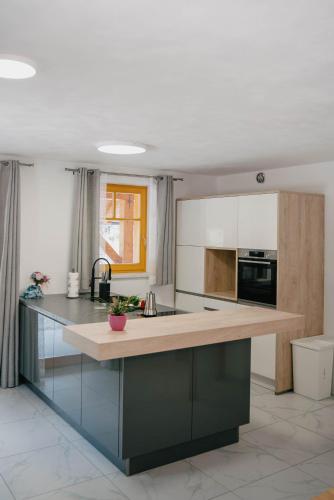 a kitchen with a large island with a counter top at Chalet HerMes arT in Idrija