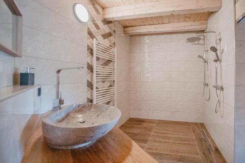 a bathroom with a bowl sink and a shower at Chalet HerMes arT in Idrija