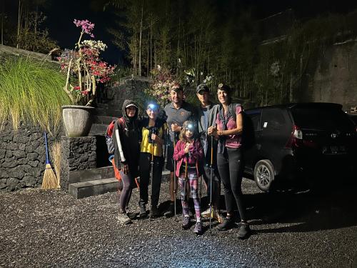 a group of people are posing for a picture at The Lava Bali Villa and Hot Spring in Kintamani