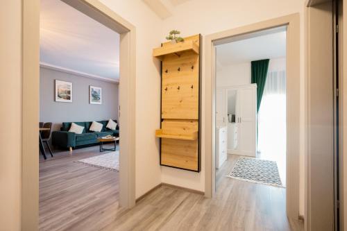 a hallway with a door leading to a living room at GreenForest Apartament Baile Felix in Baile Felix