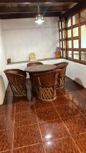 a table and some chairs in a room at Hotel del Pozo in San Sebastián del Oeste