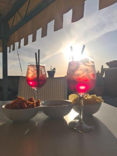 a table with a plate of food and two glasses of wine at The Life in Marcellina
