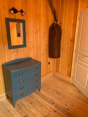 a blue dresser in a room next to a door at Lauberge de Nogaro in Caupenne-dʼArmagnac