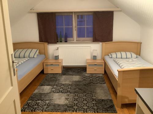 1 dormitorio con 2 camas y ventana en Villa Walter, en Leinfelden-Echterdingen