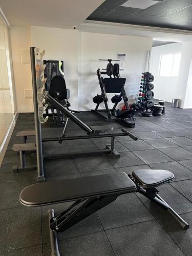 a gym with several tread machines in a room at Studio no West Fit Mossoró Nova Betania in Mossoró