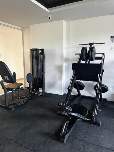 a room with several chairs and a gym at Studio no West Fit Mossoró Nova Betania in Mossoró