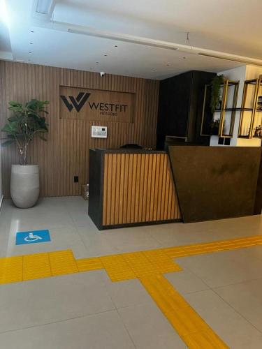 a lobby with a desk and a sign in a building at Studio no West Fit Mossoró Nova Betania in Mossoró