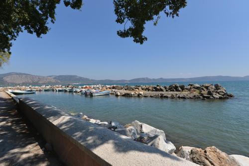 a marina with boats in the water and rocks at Villa Aggemari in Apidias Lakos