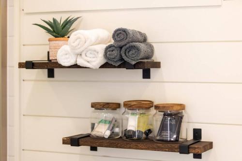 a shelf with towels and other items on a wall at New The Sunrise Cozy Container Home in Fredericksburg