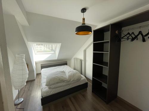 a small bedroom with a bed and a ceiling at Charmant F3 à Gérardmer Centre in Gérardmer
