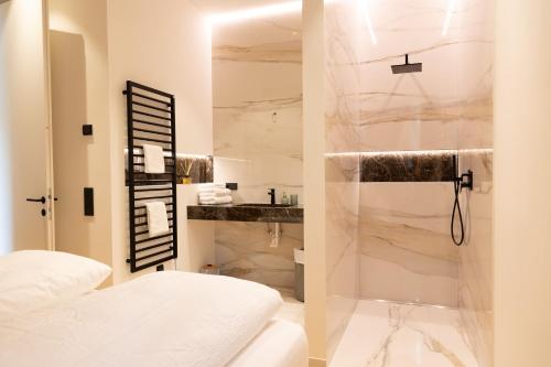 a white bathroom with a shower and a sink at Luxury Apartment Villa Ortler in Merano