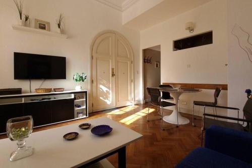 a living room with a table and a tv at Libertador recoleta in Buenos Aires