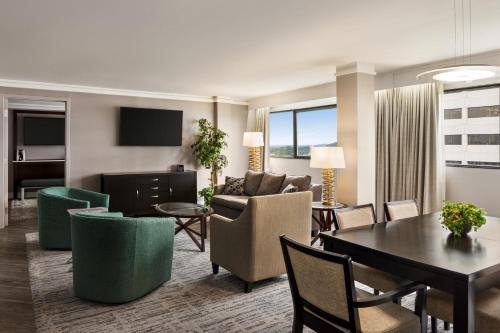 a living room with a couch and a table at Crowne Plaza Knoxville Downtown University by IHG in Knoxville
