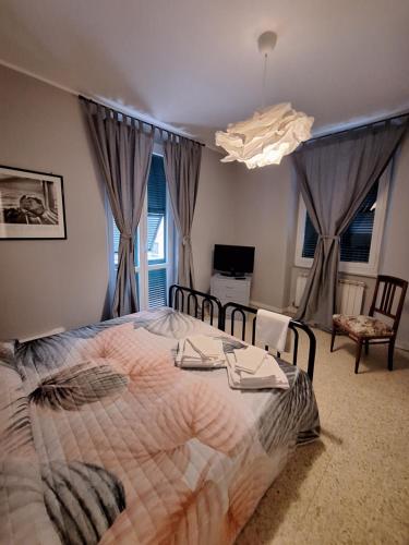 a bedroom with a bed with a comforter on it at Nest Rest in La Spezia