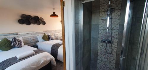 łazienka z 2 łóżkami i przeszkloną kabiną prysznicową w obiekcie Arundel Comfort En Suite Twin Friends & Family w mieście Arundel