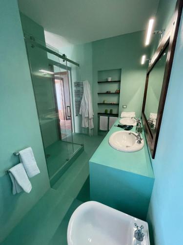 a bathroom with a sink and a mirror at DOMUS PARVA - Villa con bio-piscina, spa privata e appartamenti panoramici in Bacoli