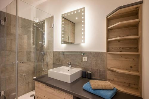 a bathroom with a sink and a shower at Aparthotel Backstage in Kufstein
