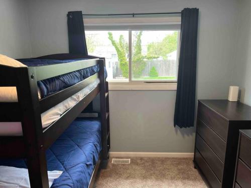 a bedroom with a bunk bed and a window at Cute home near EMU and U of M in Ypsilanti